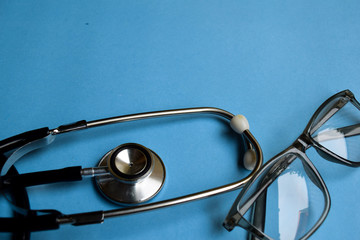 Medical concept. Stethoscope on doctor desk. Blue background