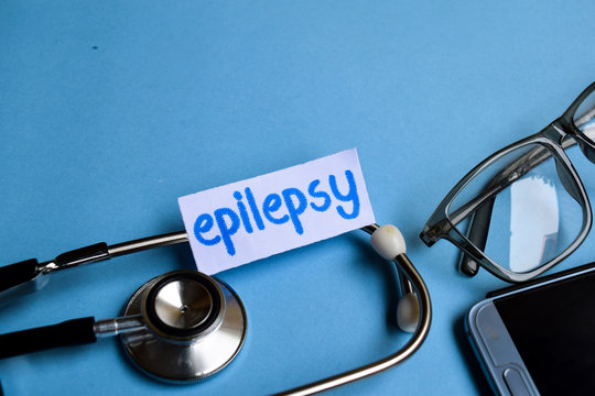 Conceptual image with Epilepsy inscription with the view of stethoscope, eyeglasses and smartphone on the blue background. Medical Conceptual.