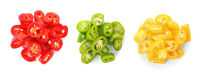 Set of different sliced chili peppers on white background