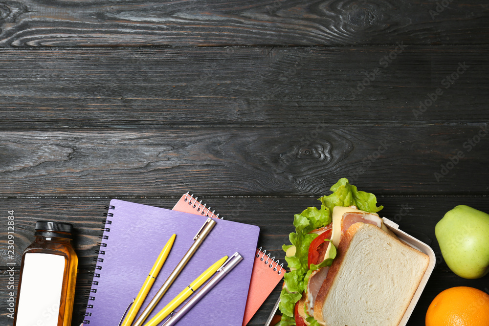 Wall mural Flat lay composition with healthy food for school child and space for text on wooden background