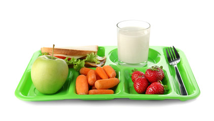 Serving tray with healthy food on white background. School lunch