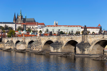 Colorful autumn Prague gothic Castle and Charles Bridge with the Lesser Town in the sunny Day, Czech Republic