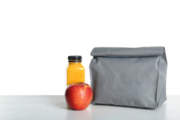 Healthy food and bag on table against white background. School lunch