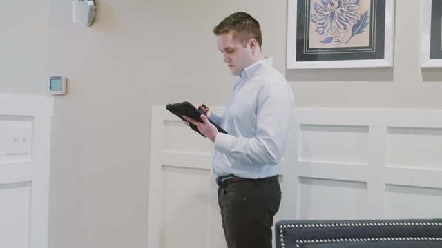 Home inspector using modern technology to complete his work assignment.