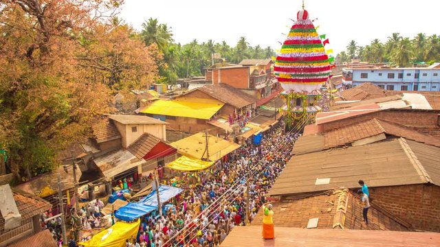Crowd pulling large ratha chariot approaching at camera in small village famous for Shiva temple during annual Maha Shivaratri festival in holy south Indian town, Gokarna, Karnataka, India. Time-lapse