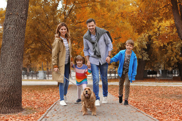 Happy family with children and dog in park. Autumn walk