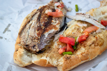 Close-up shoot of fish and bread food on the street