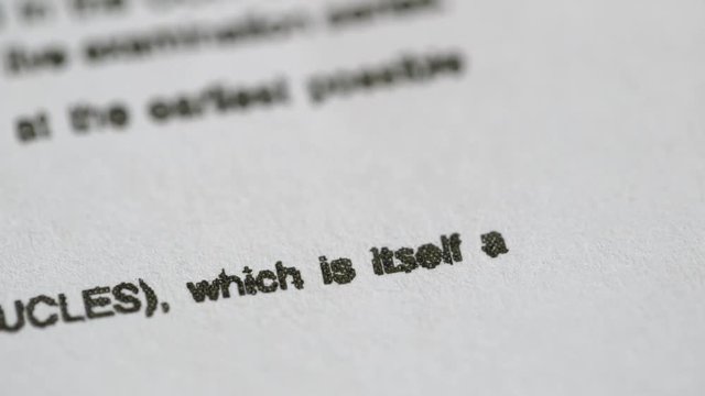 Exams: The words Turn Over written on an exam paper, fingers turning the page