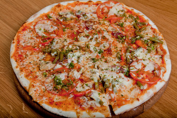 Home pizza on a wooden table.