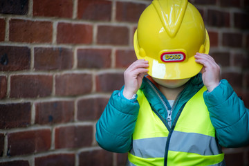 Little boy role playing a builder foreman