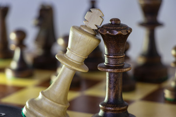 background. wooden chess pieces (white / black) placed on a chessboard