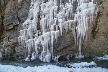 Fototapeta na wymiar melting glacier in the mountains, frozen waterfall