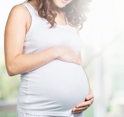 Pregnant young woman in white t shirt