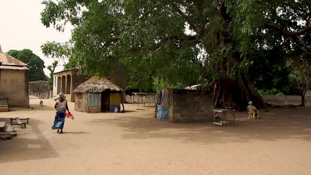 walking down a street in a small village in Senegal