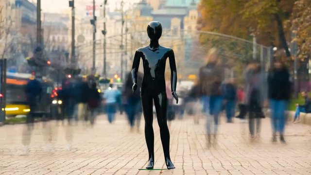 The black mannequin standing on the crowd street. time lapse