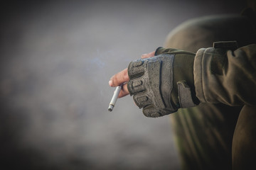 Soldier's hand with cigarette