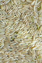 Whole grain brown rice in low light.