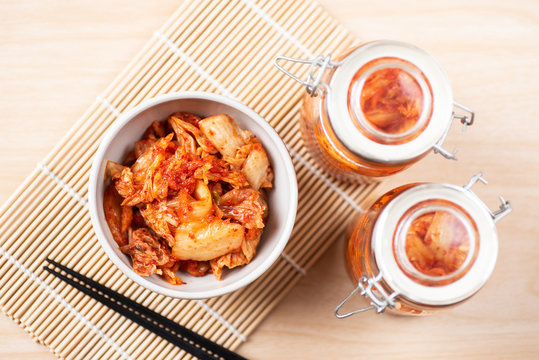 Kimchi cabbage in a bowl and jar with chopsticks for eating, Korean food