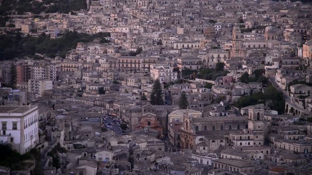 Timelapse of the Modica, Sicily - Italy  framed after the sunset. While the headlights of the cars are already lit, the lights of the city begin to be turned on. 
