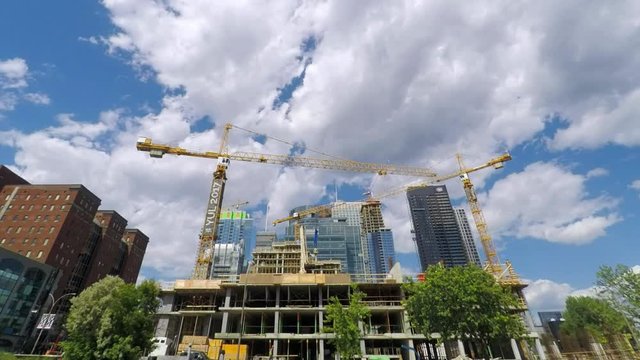 Montreal condo construction timelapse with cranes, summer, 4K