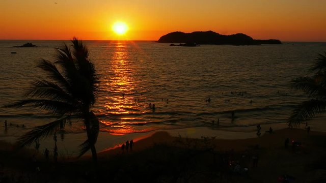 Sunset vacation beach with people, palm trees, islands, 4k