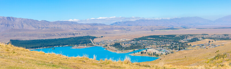 Fototapeta premium Panorama view of Lake Tekapo with city tekapo, South Island New Zealand
