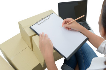 courier making notes in delivery receipt among parcels on boxes