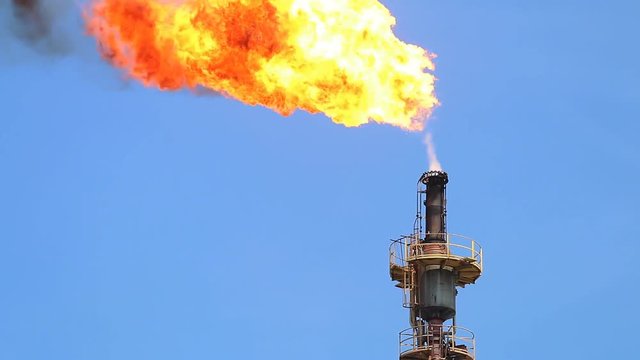Fire on flare stack at oil and gas central processing platform release over pressure from process. Petroleum refinery plant