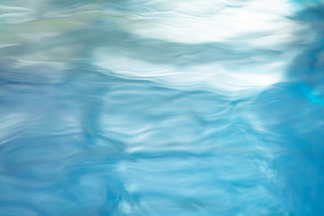 The smooth natural blue water background with bokeh  abstract on the sea or ocean,vintage and soft colored blur.