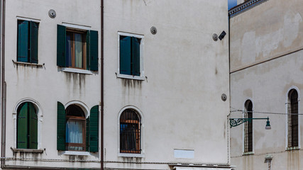 Walls and windows of Venetian houses in Venice, Italy