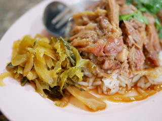 Selective focus of stewed pork leg with pickled cabbage on rice (Kao Ka Moo)