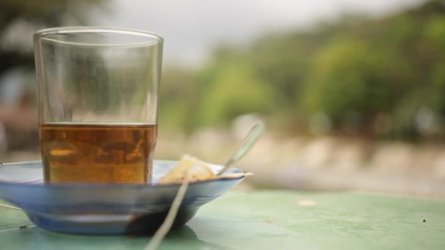 Close up of a cup of tea in an outdoor setting