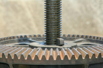 Close up metal mechanical gear on the floodgate. rusty cogwheel background