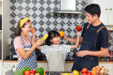 Happy family mother and father teaching cute girl preparing making Wheat flour  and Make a fruit cake healthy at kitchen for the first time. first lesson and healthy lifestyle concept.