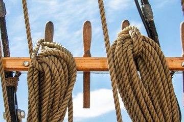 Coiled lines secured on belaying pins on a traditionally rigged 3-masted schooner on its way to the Island of Nicklösa in the Åland Islands, Finland.
