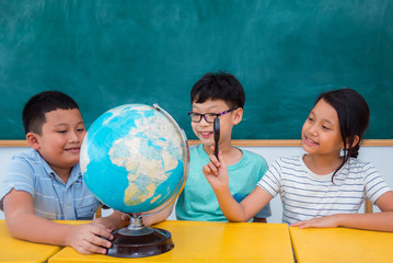 Group of asian students studying geography in classroom
