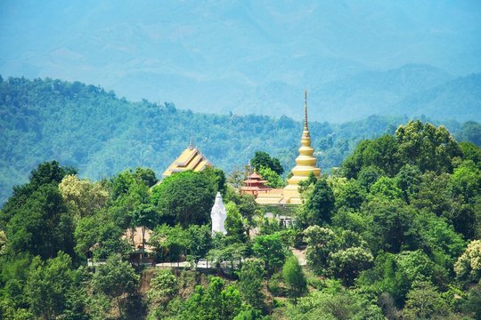 Phra That Si Maha Pho Mongkol Boom Chum at Doi Mae Slong, Chiang Rai, Thailand. Buddhist temple, pagoda and Guan Yin Statue in forest at the mountain.