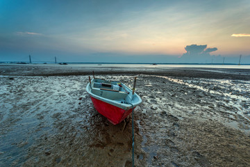 A Long exposure picture of boat with cloudy moment as background