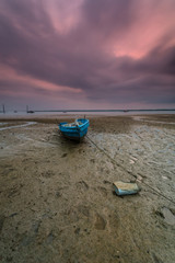 A Long exposure picture of boat with cloudy moment as background