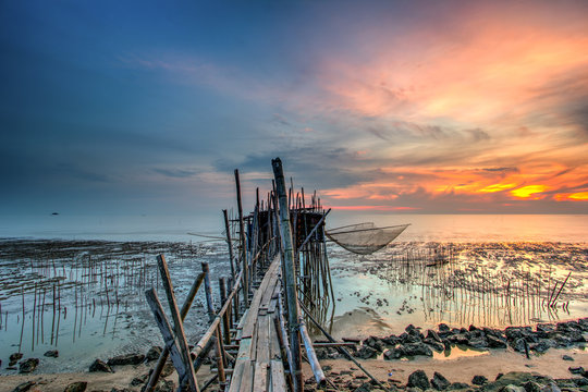 Long exposure image of "langgai" during beautiful sunset , the traditional fishing medium at Malaysia .Image has certain noise and soft focus when view at full resolution