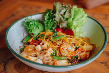 Spaghetti spicy seafood is placed on the table.