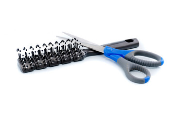 Scissors and comb isolated on white background