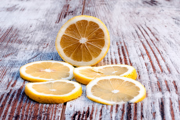 Sliced lemon surrounded by rustic background