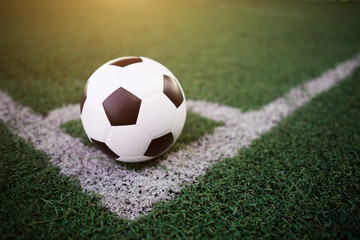 soccer ball on the white line at stadium