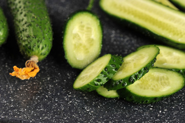 fresh green cucumbers whole and cut