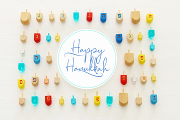 Image of jewish holiday Hanukkah with wooden dreidels colection (spinning top) over white background.