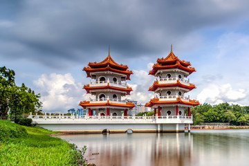 Fototapeta premium Beautiful day and cloud at Chinese Garden Twin Pagoda of Singapore with reflection