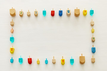 Image of jewish holiday Hanukkah with wooden dreidels colection (spinning top) over white background.