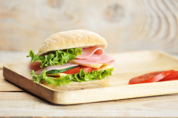 ham and cheese sandwich on wooden Board