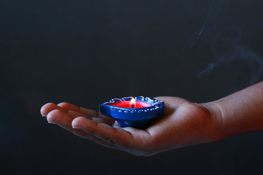 Girl holding Diyas/lamps for diwali celebration